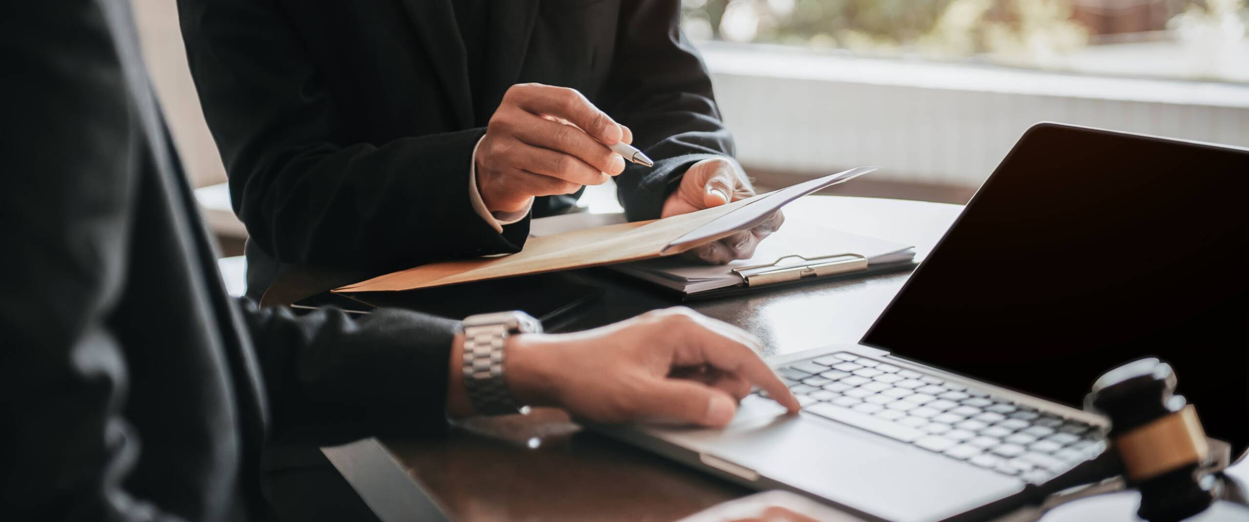 Businessman and Male lawyer or judge consult having team meeting Businessman and Male lawyer or judge consult having team meeting with client, Law and Legal services concept in office.