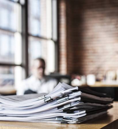 Close-up of files and file folders on a desk top in an office. Close-up of files and file folders on a desk top in an office.