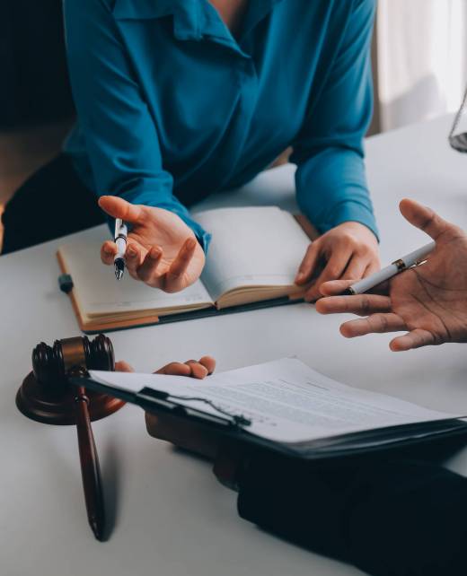Justice and Law concept. Legal counsel presents to the client a Justice and Law concept. Legal counsel presents to the client a signed contract with gavel and legal law or legal having team meeting at law firm in background